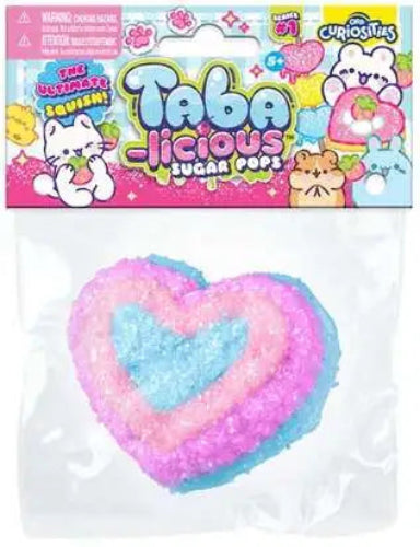 Taba Licious Sugar Pops in a heart shape, featuring a pink and blue layered design with a textured sugar coating, packaged in a clear bag with a colorful cartoon header card.