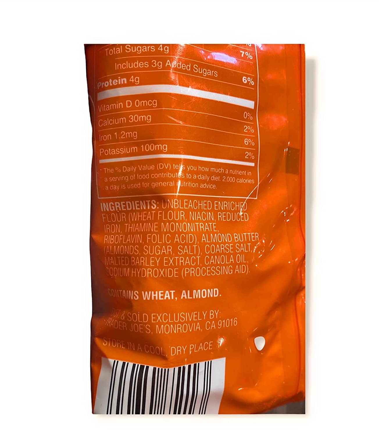 Back view of an orange snack package with nutritional information and ingredients listed.