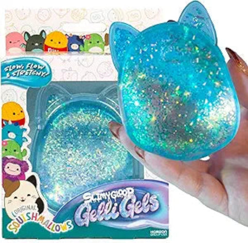 Blue glittery gelatinous product with cat ears held by a hand, branded 'Gelli Baff' and 'Squishmallows'.