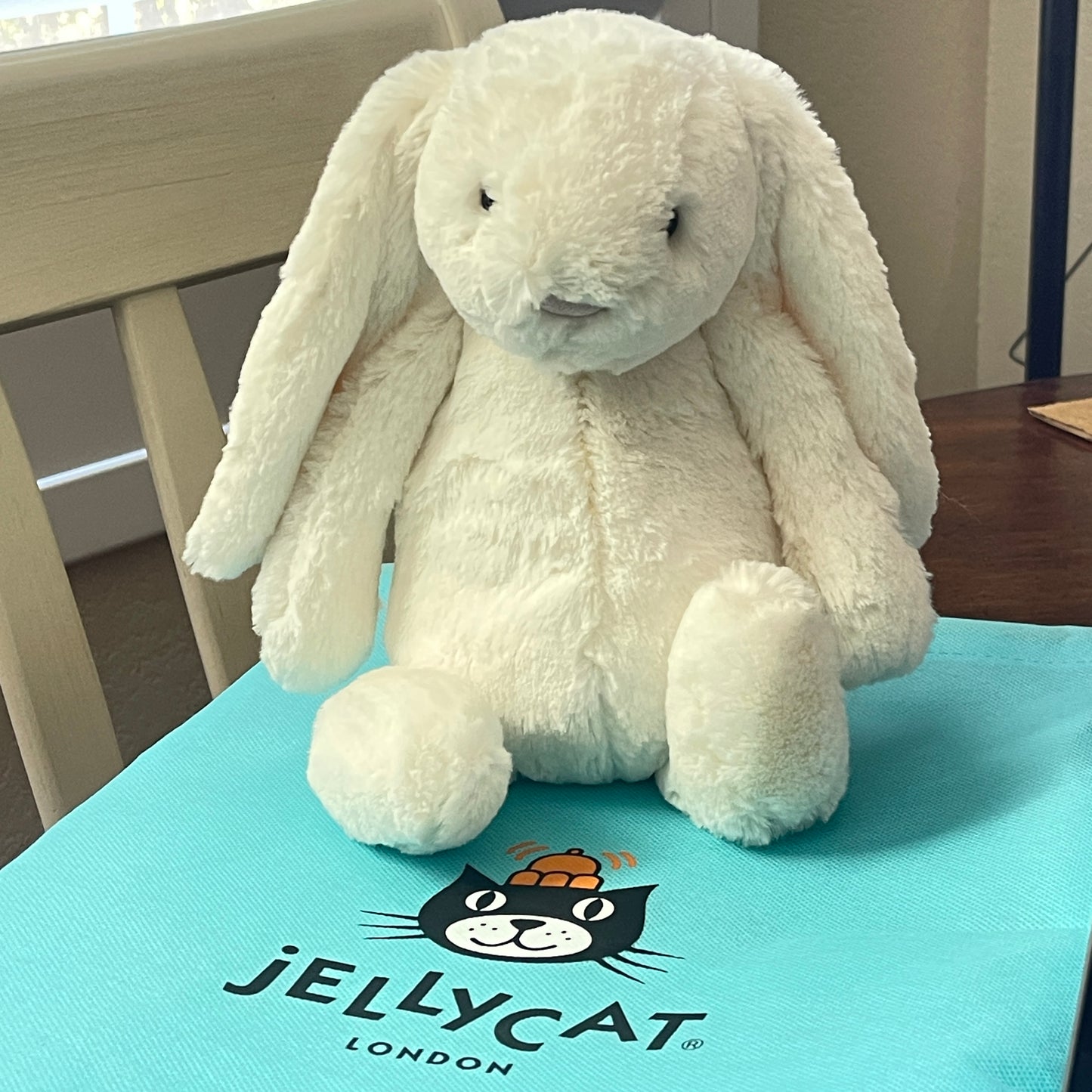 White plush bunny toy on a Jellycat branded mat
