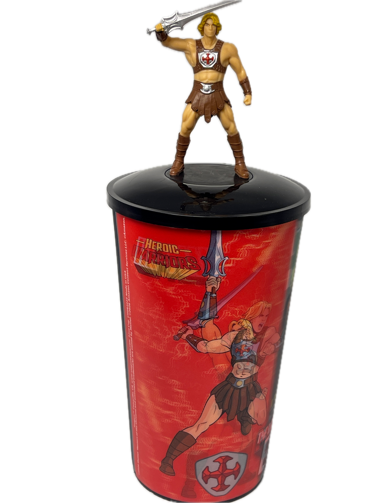 He-Man action figure posed beside a red cylindrical display tube featuring He-Man and the title 'The Power of the Classic Heroes' on a white background.