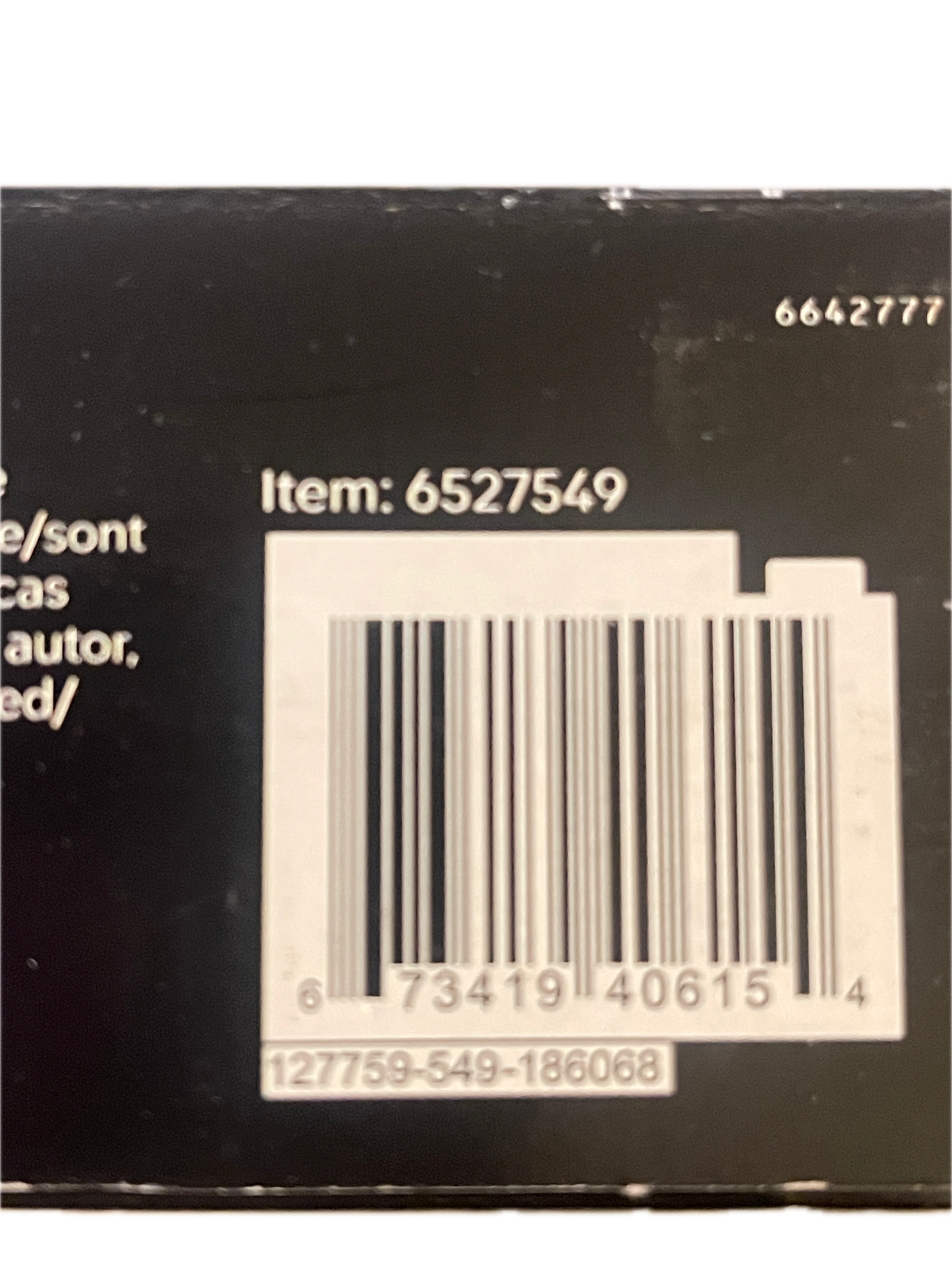 Close-up of a black product box showing a white barcode, item number 6527549, and partial text on a white background.