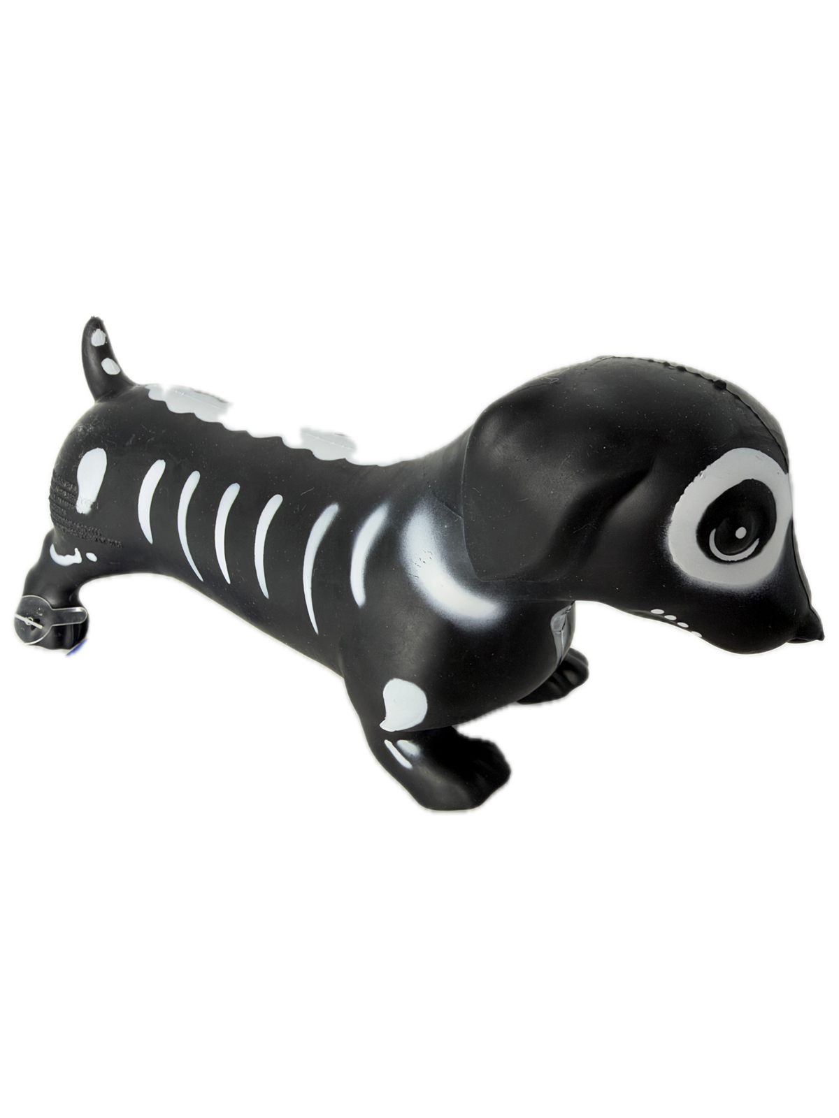 A black and white SQUISHY WEINER DOG shaped like a skeleton, standing upright on its hind legs against a plain white background.