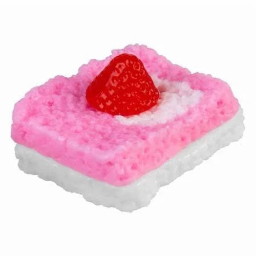 A novelty squishy toy shaped like a strawberry shortcake, featuring a textured pink top layer, a white crumbly middle layer, and a glossy red strawberry on top, isolated on a white background.
