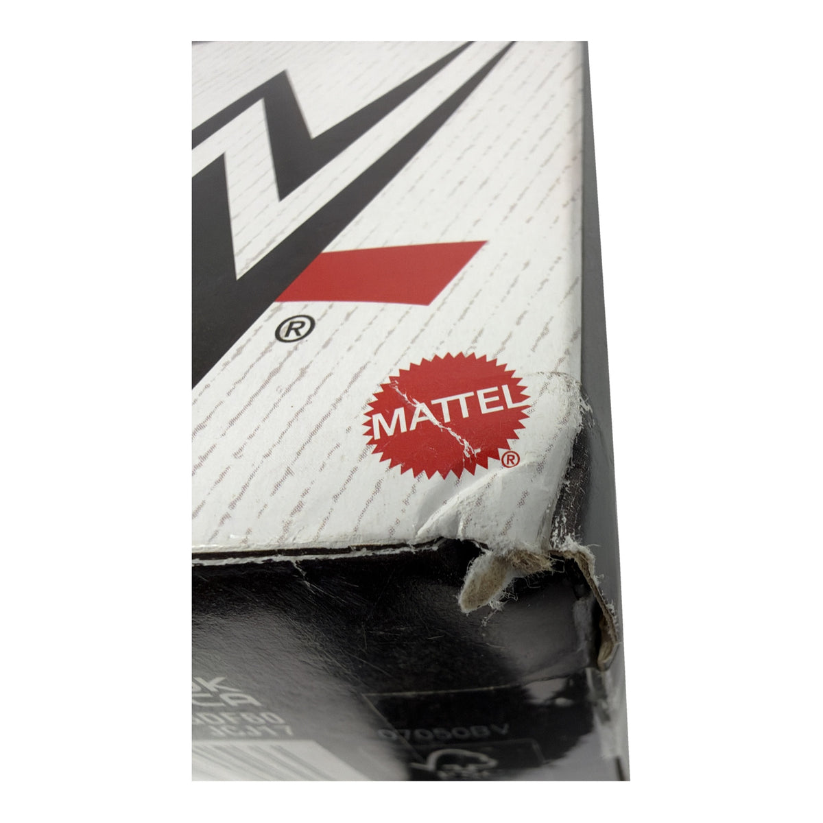 Box damage close-up: torn and crushed bottom corner near the Mattel logo, figure sealed and unaffected