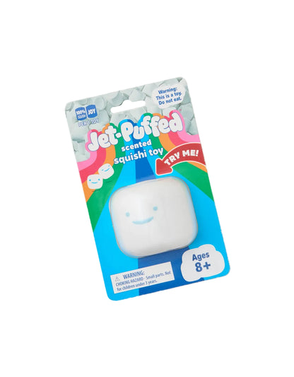 A packaged Jet-Puffed scented squishy toy in its retail blister packaging, photographed on a plain light beige background. The product is a small white rounded squishy with a simple smiley face, and the packaging prominently shows the Jet-Puffed brand and age rating.