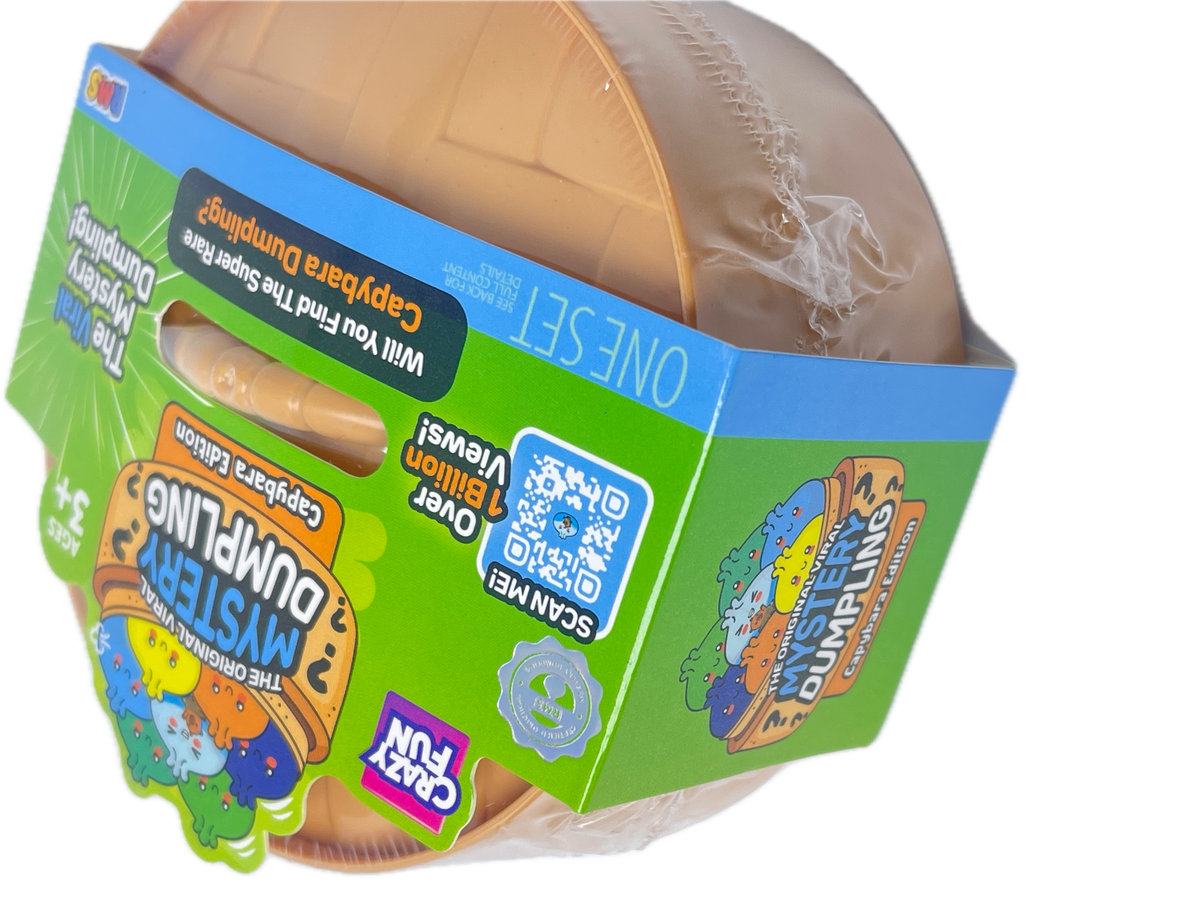 A toy capsule mystery dump package from Crazy Fun, featuring a brown plastic capsule partially wrapped in clear plastic, with a bright green and blue cardboard sleeve displaying product graphics and a QR code.