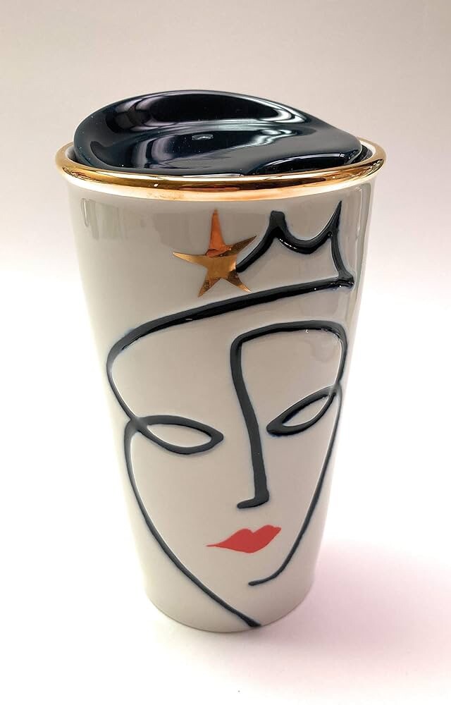 Travel mug with face design and gold accents on a white background