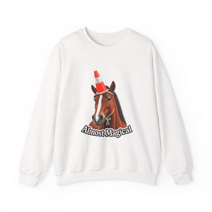 An off-white crewneck sweatshirt featuring a graphic of a brown horse wearing an orange and white traffic cone, with the text 'Almost Magical' printed below.