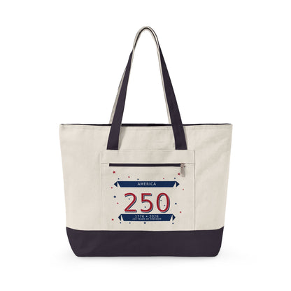 A canvas tote bag with an off-white body, dark navy blue handles and bottom trim, and a front pocket featuring a patriotic '250 America' graphic.