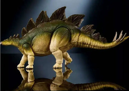 A detailed Stegosaurus dinosaur toy figurine with textured green and yellow-green skin, standing on a reflective black surface against a dark background.