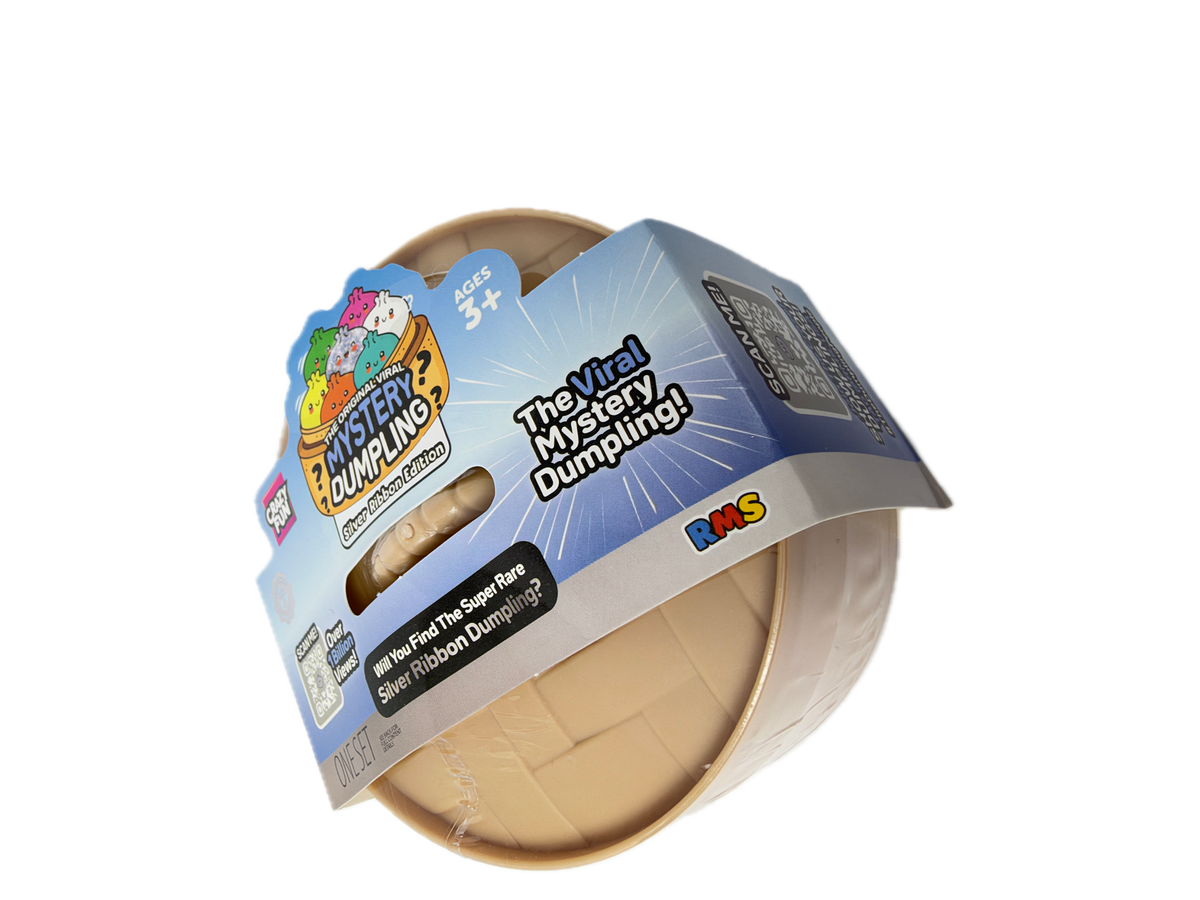 A packaged toy product labeled 'Mister Dumbleo' on a white background. The item appears to be a silver foil-dipped dumpling in a clear plastic cup, with a blue and white cardboard sleeve showing product branding and text.