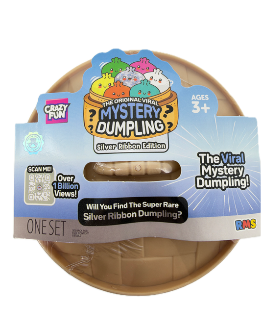 A packaged toy product labeled 'The Viral Mystery Dumpling!' with a blue and white paper sleeve and a beige plastic dumpling visible through a clear window. The package includes branding such as 'Crazy Pets' and 'The Original Witty Mystery Dumpling!' with a 'One Set' label.