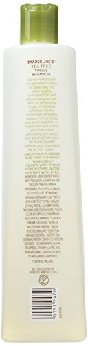 Shampoo bottle with green cap and white label on a beige background