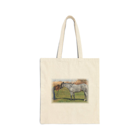 An off-white canvas tote bag with two handles, featuring a printed illustration of a gray horse standing in a grassy field on the front.