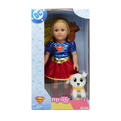 DC Comics My Life As Supergirl doll in its original retail packaging, featuring a blonde doll dressed in a blue and red costume with a gold belt, accompanied by a small white dog figure.
