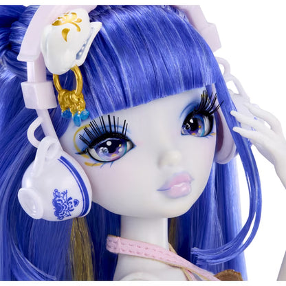 Close-up of a doll with long blue hair, large expressive eyes, and white-and-pink accessories, including a teacup-shaped accessory with blue floral detailing.