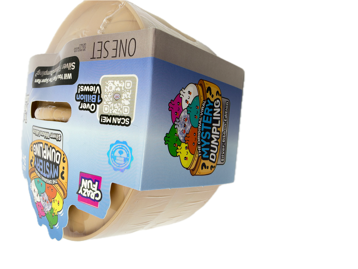 A Cuddly Fun brand 'Mystery Dumpying' one-set toy package, showing a beige plastic container partially visible through clear wrapping with colorful cartoon graphics and product details on the cardboard sleeve.