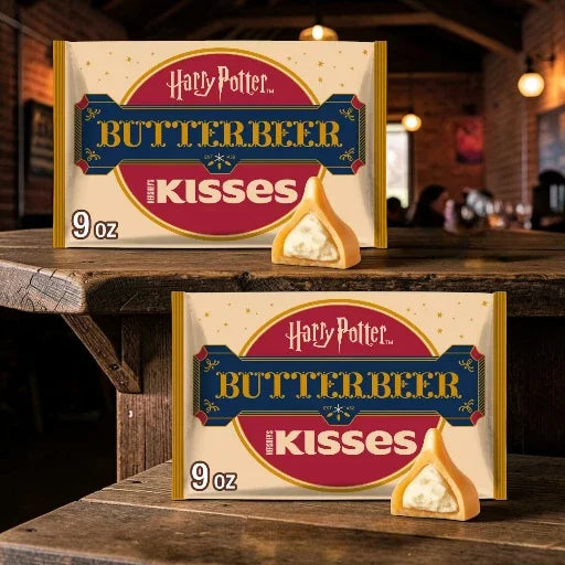 Two packages of Harry Potter Butterbeer Kisses on a wooden surface with a blurred background.