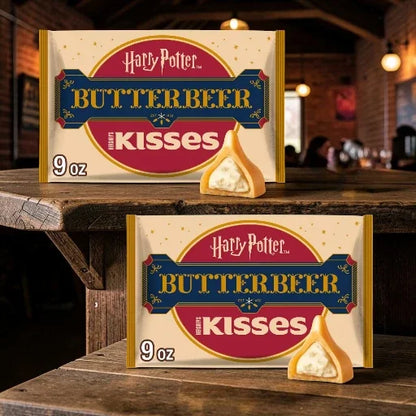 Two packages of Harry Potter Butterbeer Kisses on a wooden surface with a blurred background.