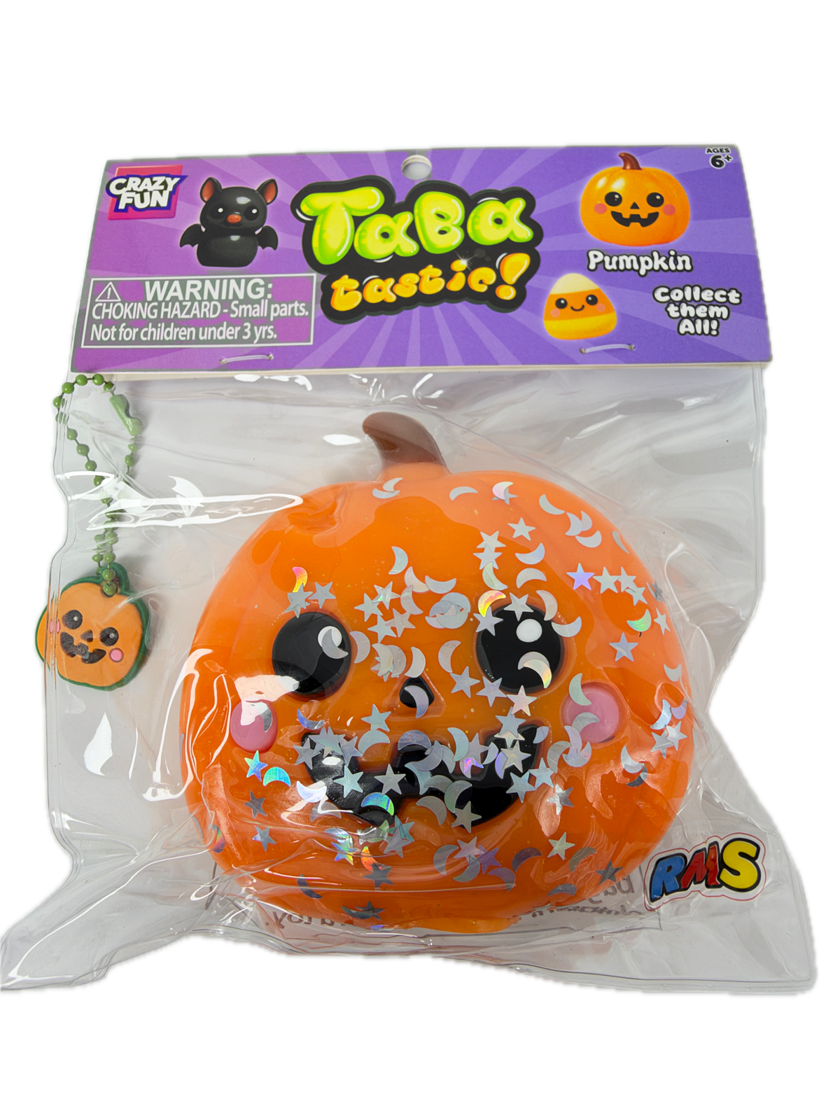 A packaged orange pumpkin squishy toy with a cartoon face, silver star and moon stickers, and a small pumpkin keychain attached, shown in its retail blister packaging on a white background.