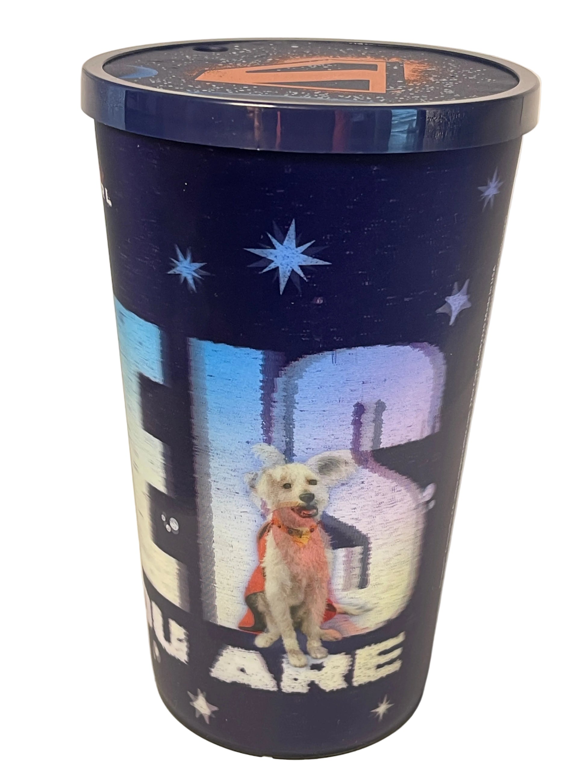 A cylindrical metal tin with a dark blue space-themed design featuring stars, a cartoon dog in a space suit, and large white text, photographed on a plain light background.