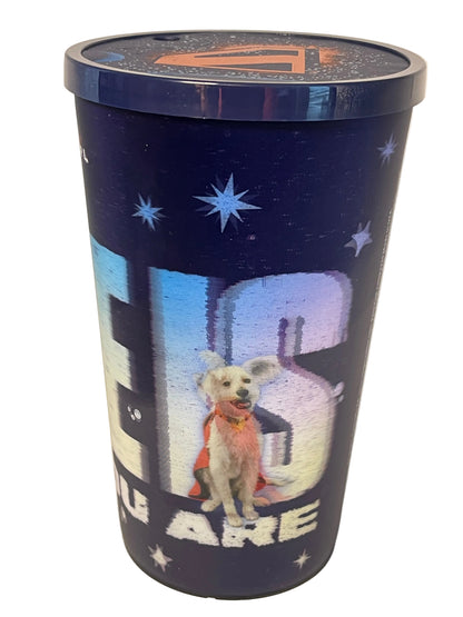 A cylindrical metal tin with a dark blue space-themed design featuring stars, a cartoon dog in a space suit, and large white text, photographed on a plain light background.