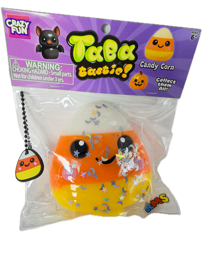 A packaged Tabz Freaky! Candy Corn squishy toy by Crazy Fun, sealed in clear plastic with a purple retail card insert. The toy is orange and yellow with a white top section, cartoon eyes, and scattered star and moon stickers, plus a small hanging candy corn charm.