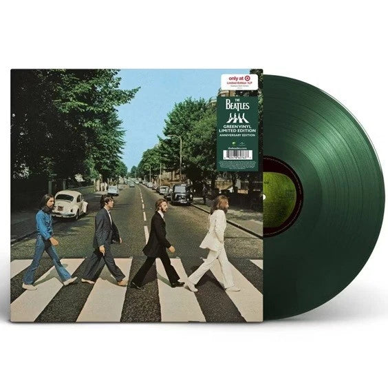 Vinyl record with 'Abbey Road' cover featuring The Beatles crossing zebra crossing.