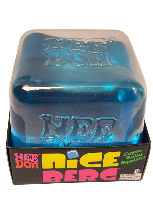 A blue translucent squishy toy inside a clear plastic clamshell package, shown next to its black retail box with colorful 'Nice Dog' branding on a white background.