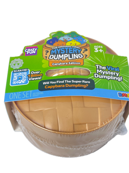 A packaged toy product labeled 'The Mint Mystery Dumping!' with a green and blue cardboard hanger card and a clear plastic wrap around a round beige/tan object inside a clear container. The packaging prominently shows the brand 'Crazy Pan' and product line text.