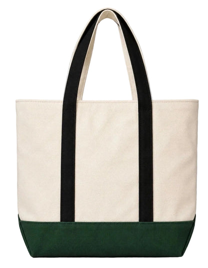 Tote bag with black straps and green bottom section on a gray background