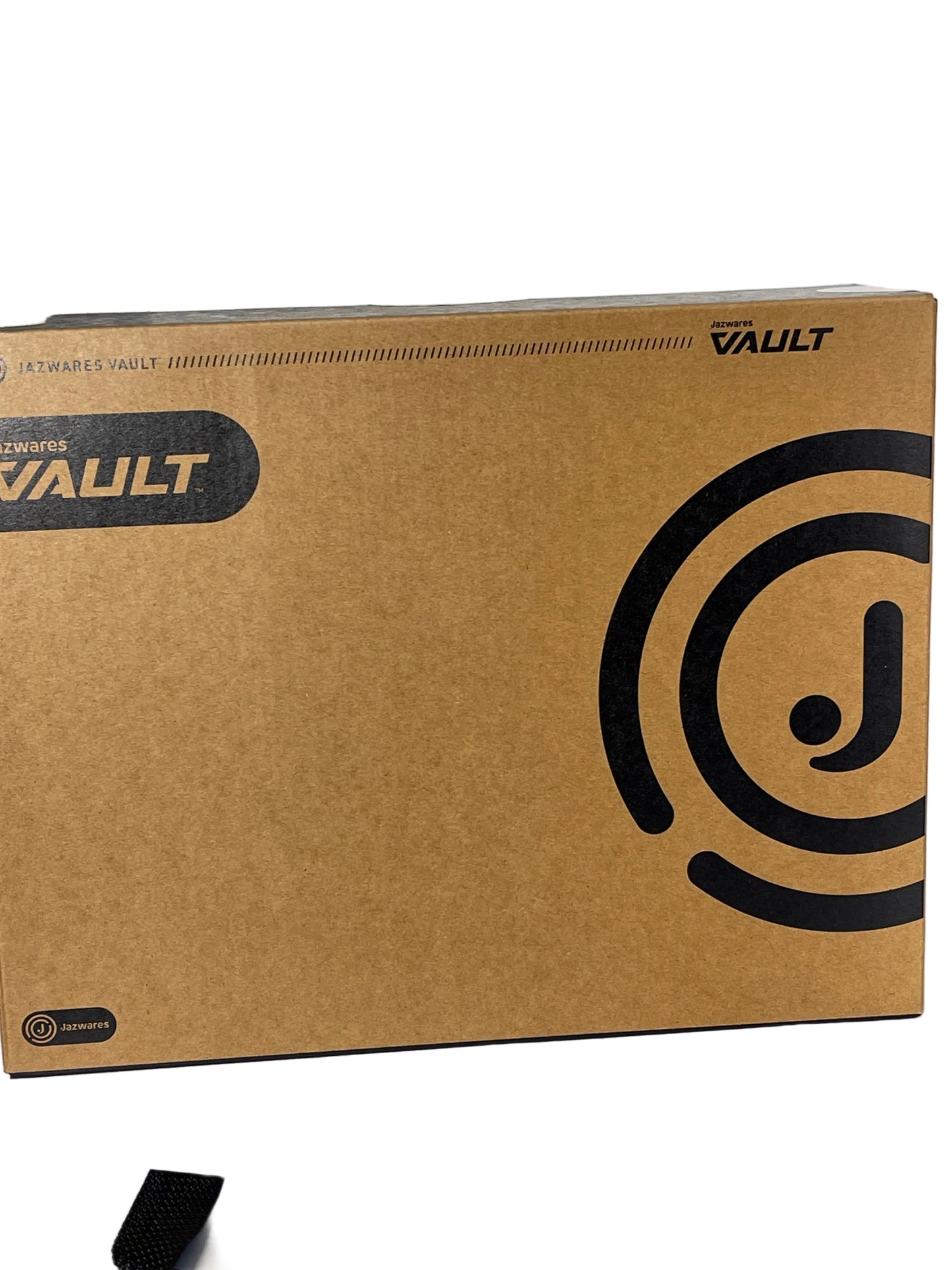 A brown cardboard box for Enigma Vault software, featuring black printed logos and text, photographed on a white surface.