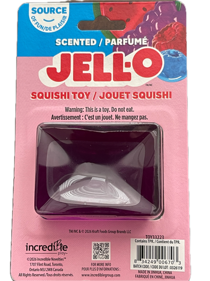 A pink Jell-O branded squishy toy in its retail packaging, with a clear plastic blister and a dark purple translucent squishy inside. The package includes Jell-O branding, a barcode, and an incretlife logo.
