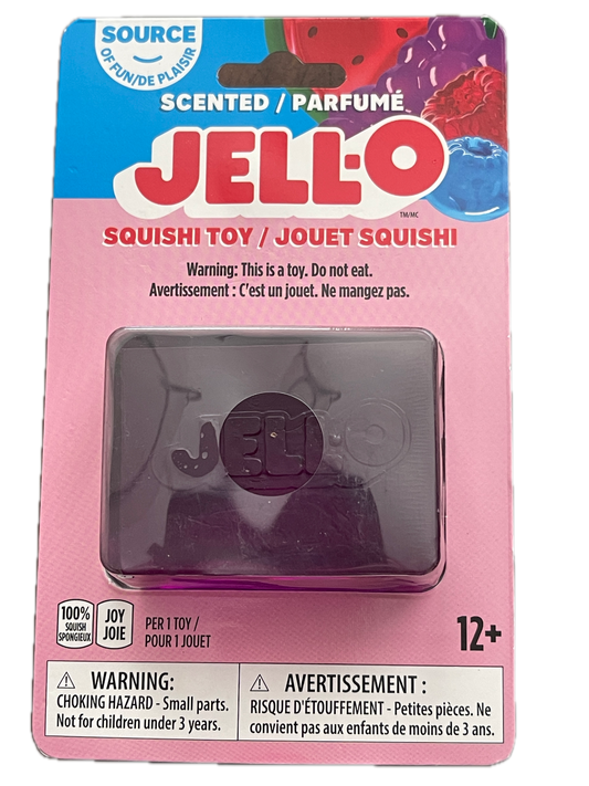 Jell-O Squishi Toy in its original pink and blue cardboard packaging, featuring a translucent purple square squishy toy inside a clear plastic window.