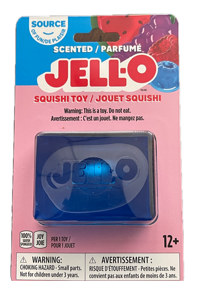 Packaged Jell-O Scented Perfumé Squishy toy in pink and blue cardboard packaging with product details and warning labels visible.