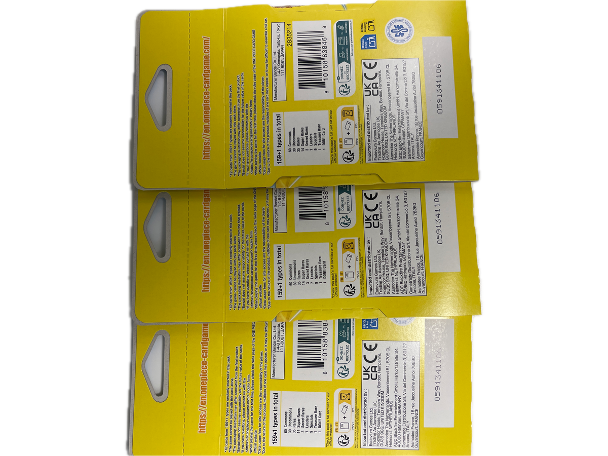Three yellow cardboard retail hang cards or packaging inserts stacked vertically, showing printed barcodes, regulatory labels, and hang tabs on a plain white background.