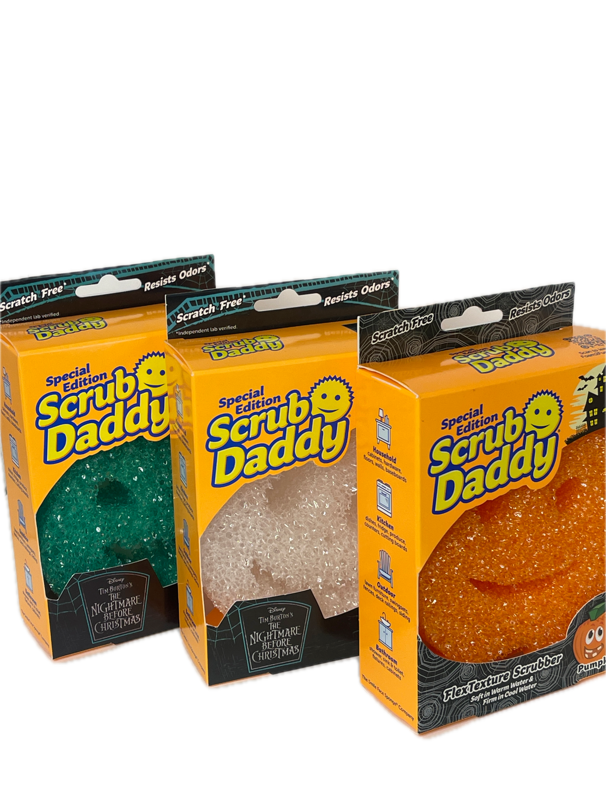 Three packaged Halloween-themed Scrub Daddy products stacked vertically on a white background. The packages are orange with black and yellow branding, showing the scrubby inside: a textured orange scrubby at the top, a translucent white/clear scrubby in the middle, and a dark green scrubby at the bottom.