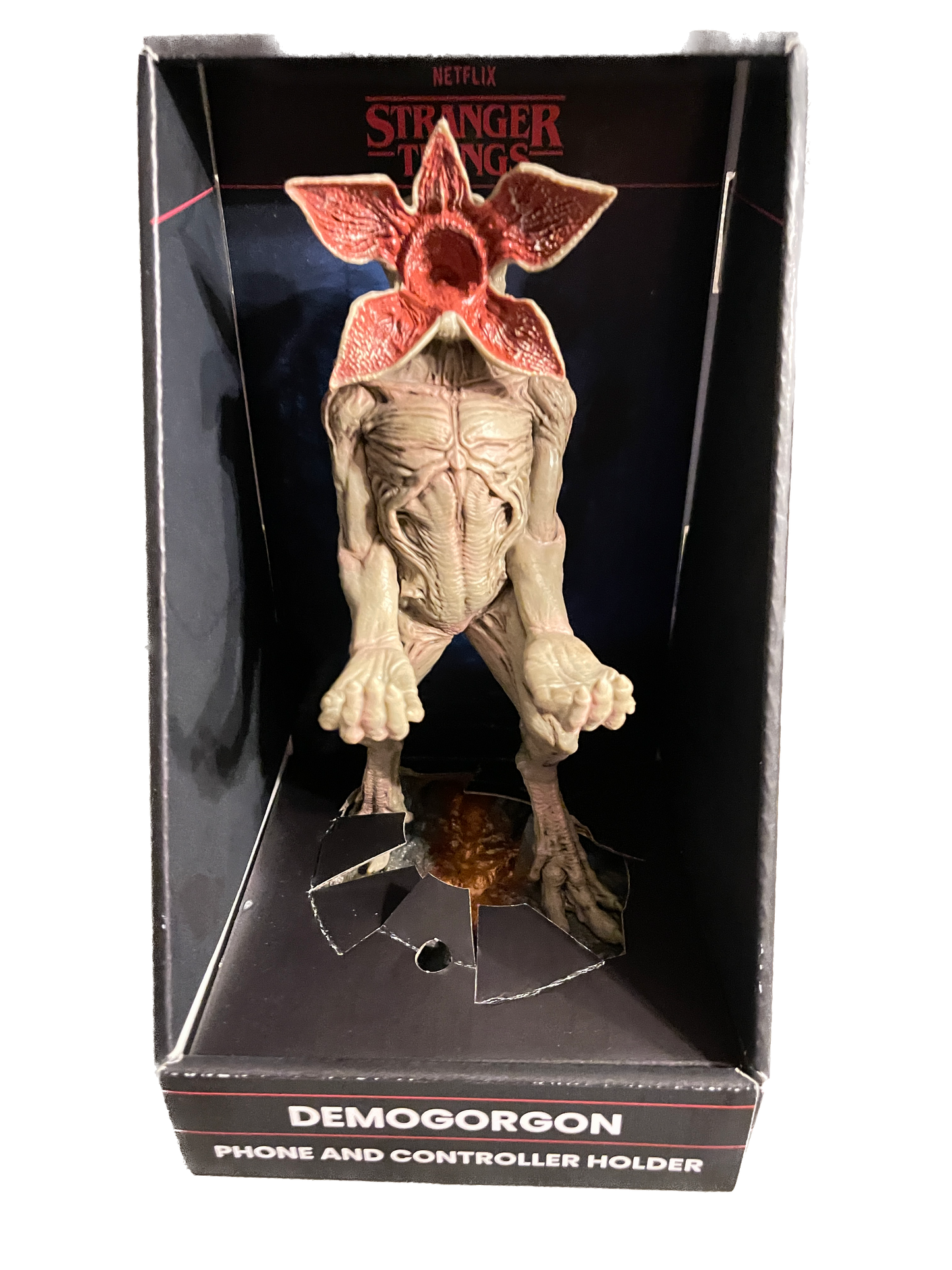 Demogorgon phone and controller holder in packaging with 'Stranger Things' branding.