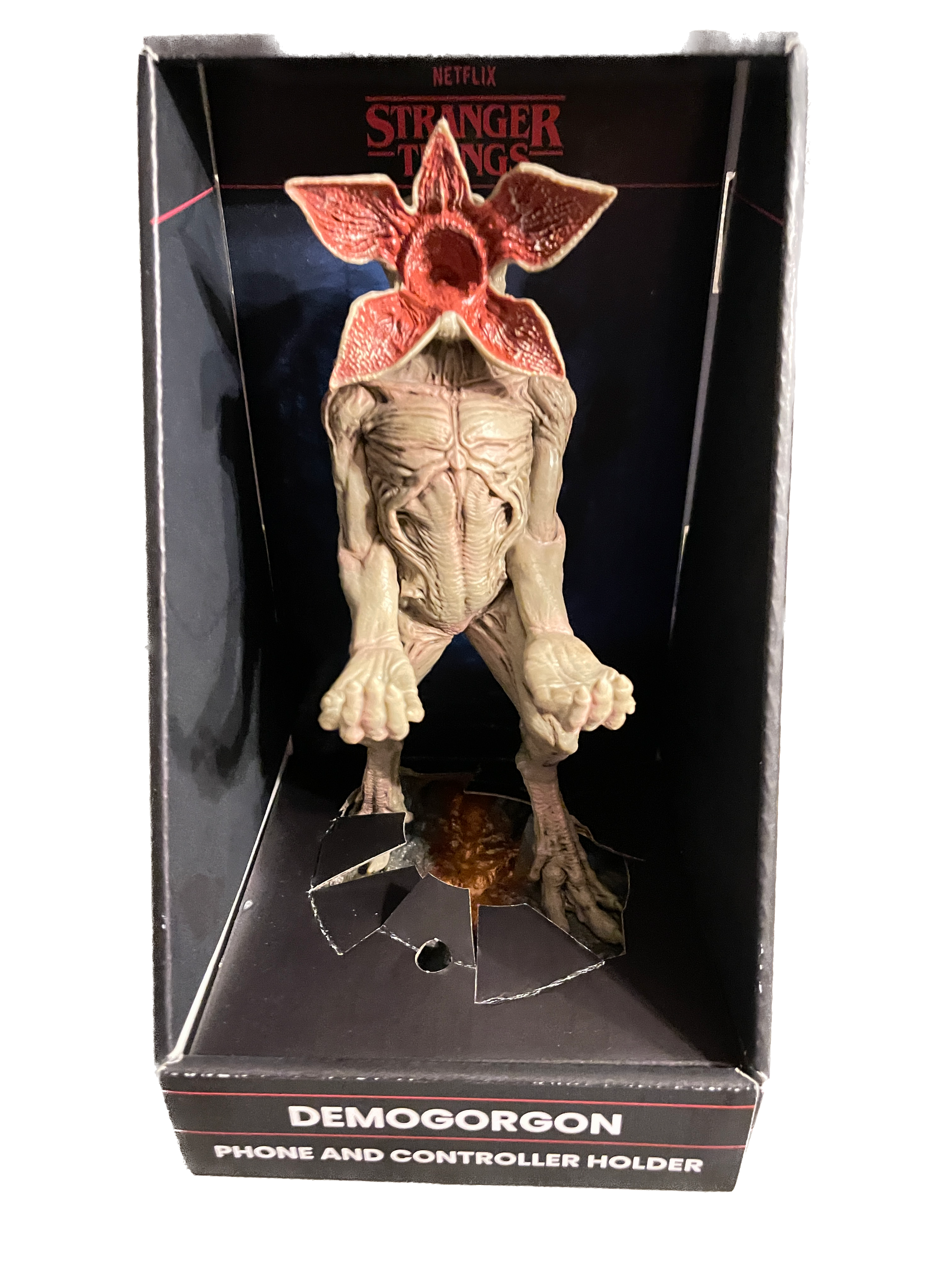 Demogorgon phone and controller holder in packaging with 'Stranger Things' branding.
