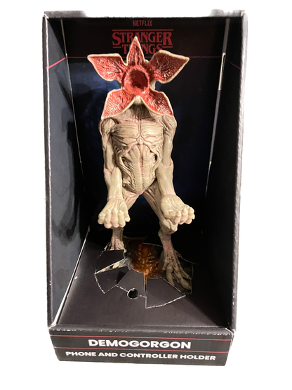 Demogorgon phone and controller holder in packaging with 'Stranger Things' branding.