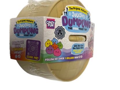 A roll of Crazy Fun Dimples The Magic Toy, wrapped in clear plastic with a colorful paper band label. The toy consists of beige plastic dimples visible through a cutout in the band.