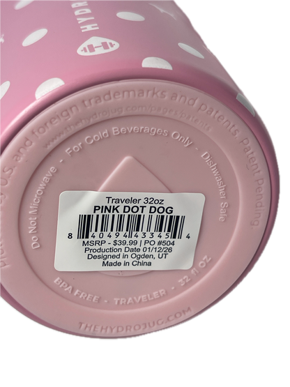 Close-up of the bottom of a pink polka-dot travel tumbler showing a white barcode label that reads 'Traveler 32oz PINK DOT DOG'.