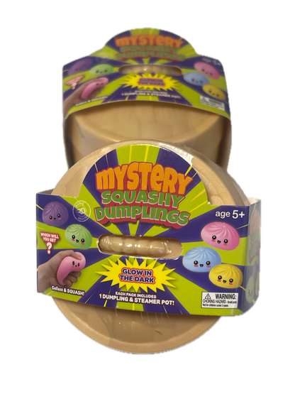 A pack of Mystery Squashy Dumpings toy figures in their original packaging, featuring a beige plastic container with colorful cartoon graphics and a clear window showing a small squishy figure inside.