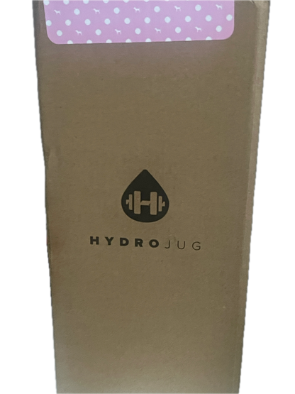 A close-up of a brown cardboard box with a black printed logo and the word 'HYDROJUG' on the side, next to a pink label with white polka dots.