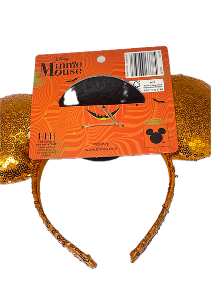 Disney Minnie Mouse Halloween headband with gold glitter ears and a black Mickey-shaped moon topper, attached to an orange retail card.
