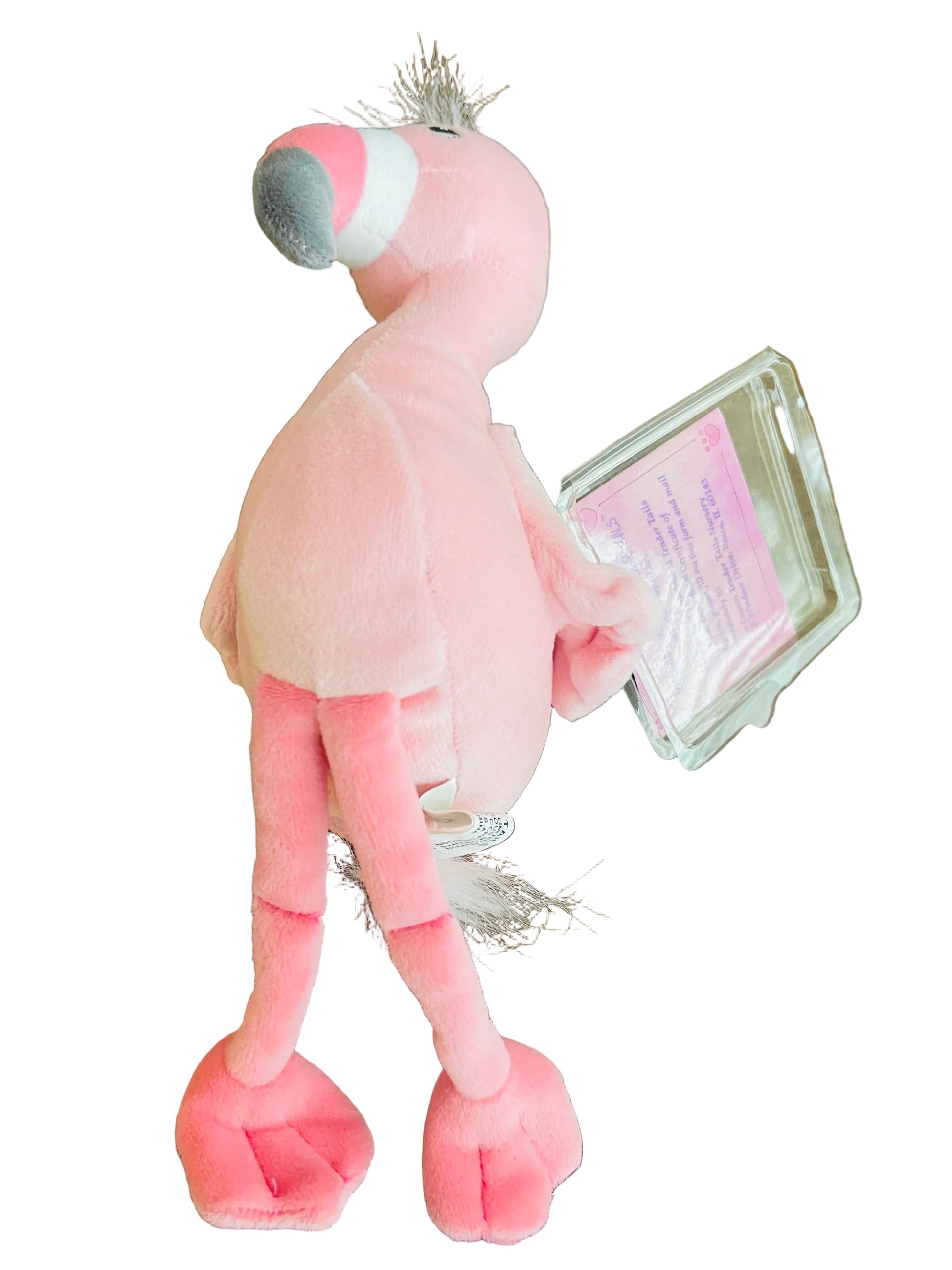 Pink plush flamingo toy on a wooden surface