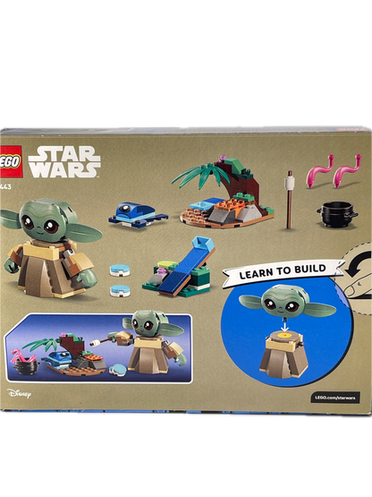 LEGO Star Wars The Child (Grogu) build box showing various toy pieces and assembly instructions on a beige background.