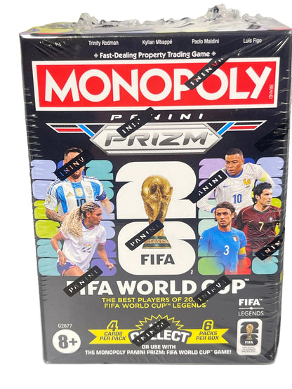 A sealed box of Monopoly Panini Prizm FIFA World Cup 2026 trading cards, featuring player portraits and the FIFA logo on the front, photographed on a light surface with another box partially visible at the left edge.