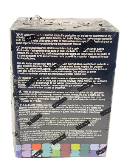 The back of a sealed black card deck box, showing printed warranty and care instructions in multiple languages, with a row of small illustrated card colors along the bottom edge and several black sticker seals across the front.